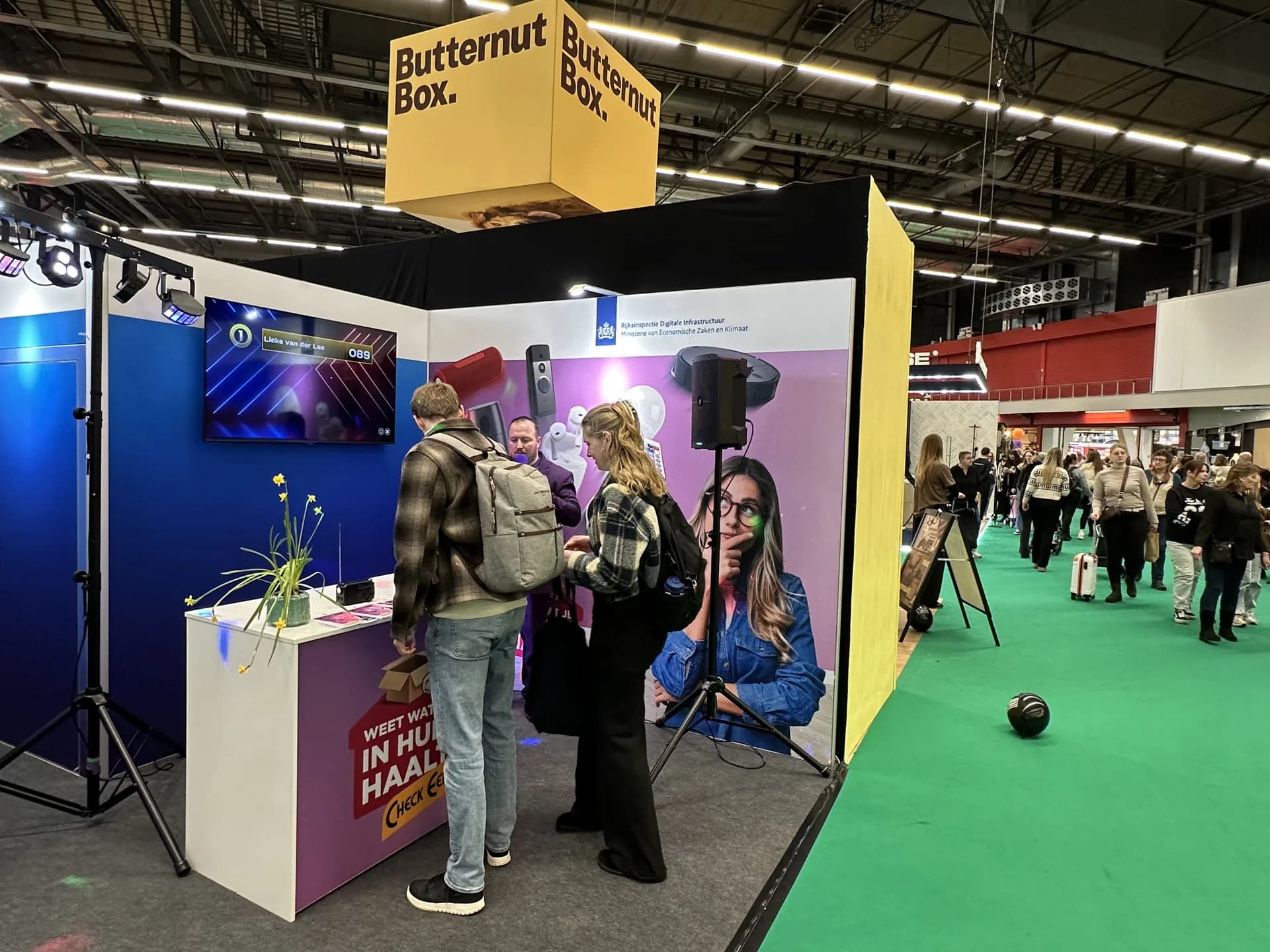 Beursstand met quizscherm en bezoekers die meespelen op de Huishoudbeurs